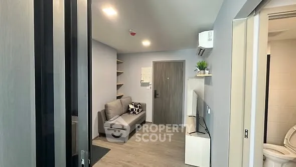 Modern living room with sleek design and cozy seating in a stylish apartment.