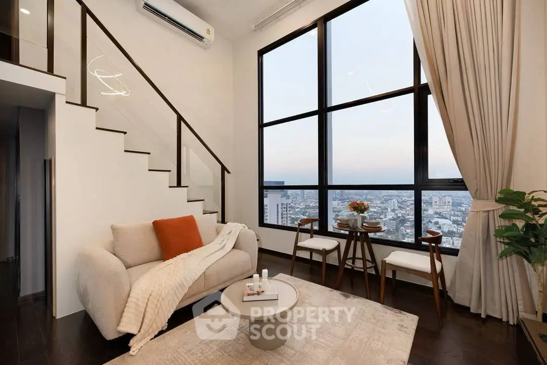 Modern living room with large windows and city view, featuring cozy seating and elegant decor.