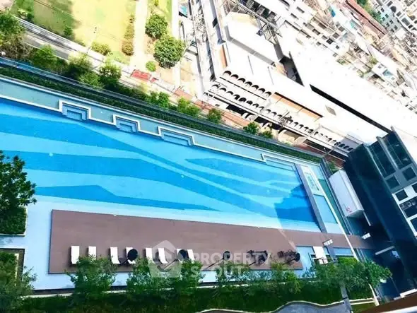 Luxurious rooftop pool with sun loungers and stunning city views, perfect for relaxation and leisure.