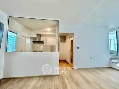 Modern open-plan living space with sleek kitchen and large windows