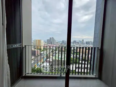 Stunning city view from modern high-rise balcony with sleek railing.