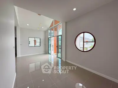 Spacious modern living room with high ceilings and large windows