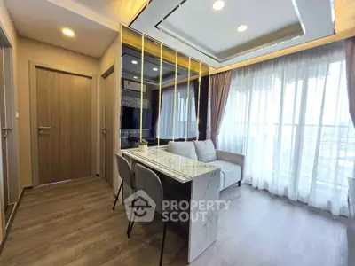 Modern living room with elegant decor and large windows for natural light.