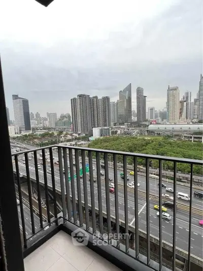 Stunning cityscape view from a high-rise balcony overlooking bustling urban skyline.