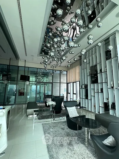 Luxurious modern living room with unique ceiling decor and stunning city view.
