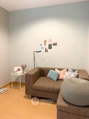 Cozy living room with modern sofa and stylish decor in a bright apartment.