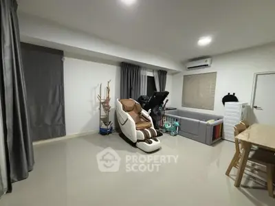 Spacious living room with massage chair and modern decor