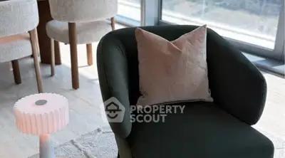 Modern living room with stylish armchair and city view