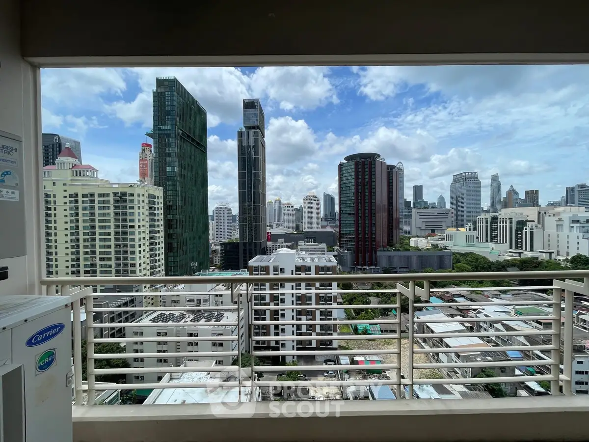 Stunning cityscape view from a modern balcony in a high-rise building.