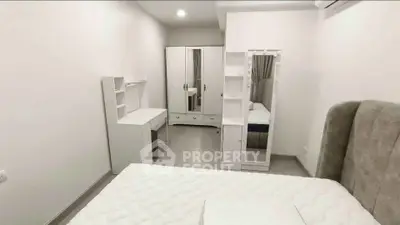 Modern minimalist bedroom with white furniture and cozy bed