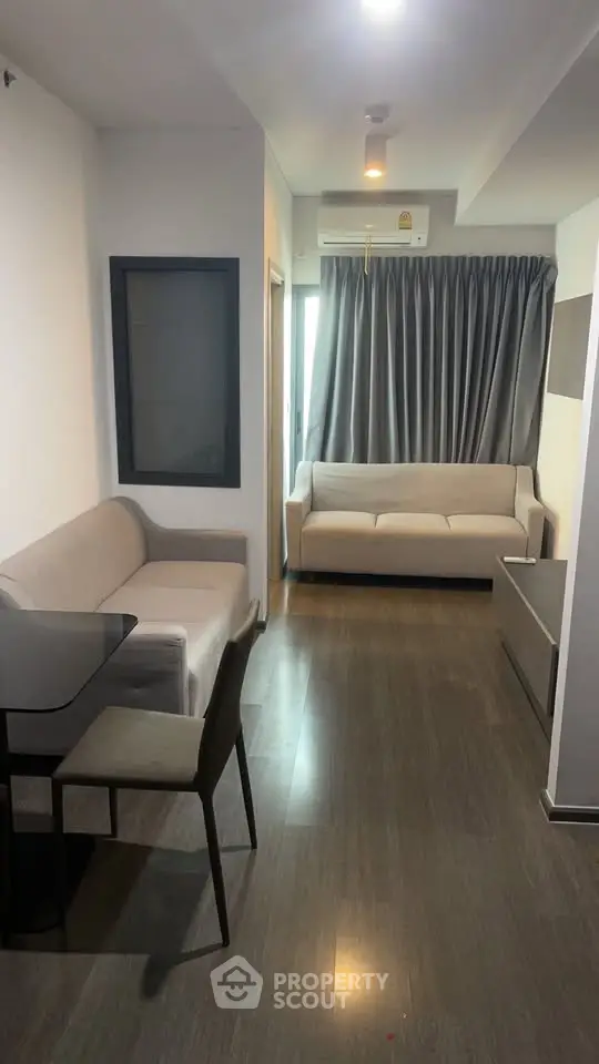 Modern living room with sleek furniture and large window for natural light