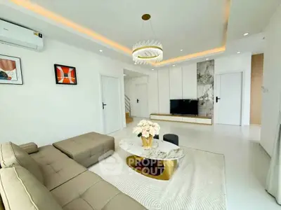 Luxurious modern living room with elegant chandelier and stylish decor