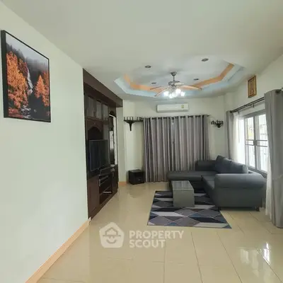 Spacious living room with modern decor and large windows for natural light.