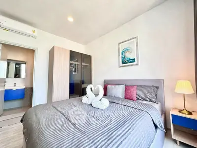 Modern bedroom with stylish decor and ensuite bathroom in a cozy apartment.