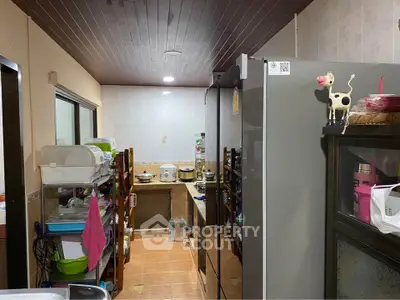 Cozy kitchen with modern appliances and ample storage space, perfect for culinary enthusiasts.