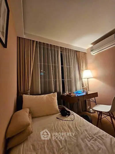 Cozy bedroom with elegant decor, featuring a comfortable bed, stylish desk, and ambient lighting.