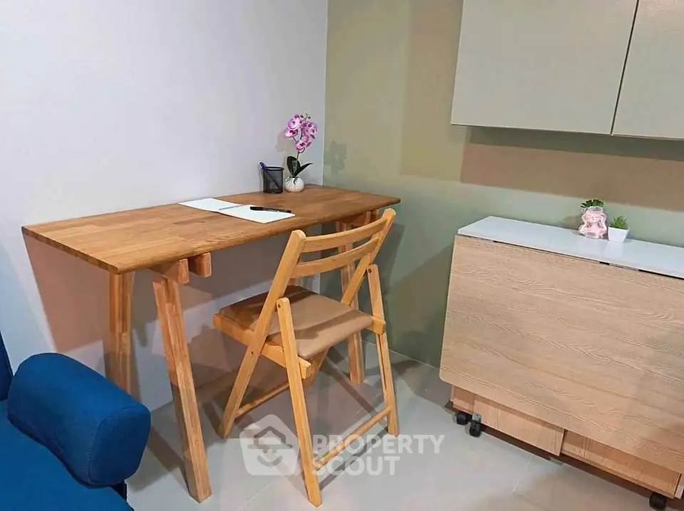 Cozy study nook with wooden desk and chair, perfect for home office setup.