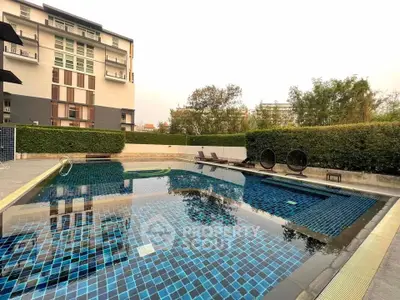 Luxurious residential pool area with modern design and lush greenery.
