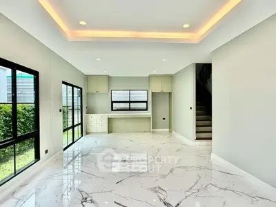 Spacious modern living room with marble flooring and large windows