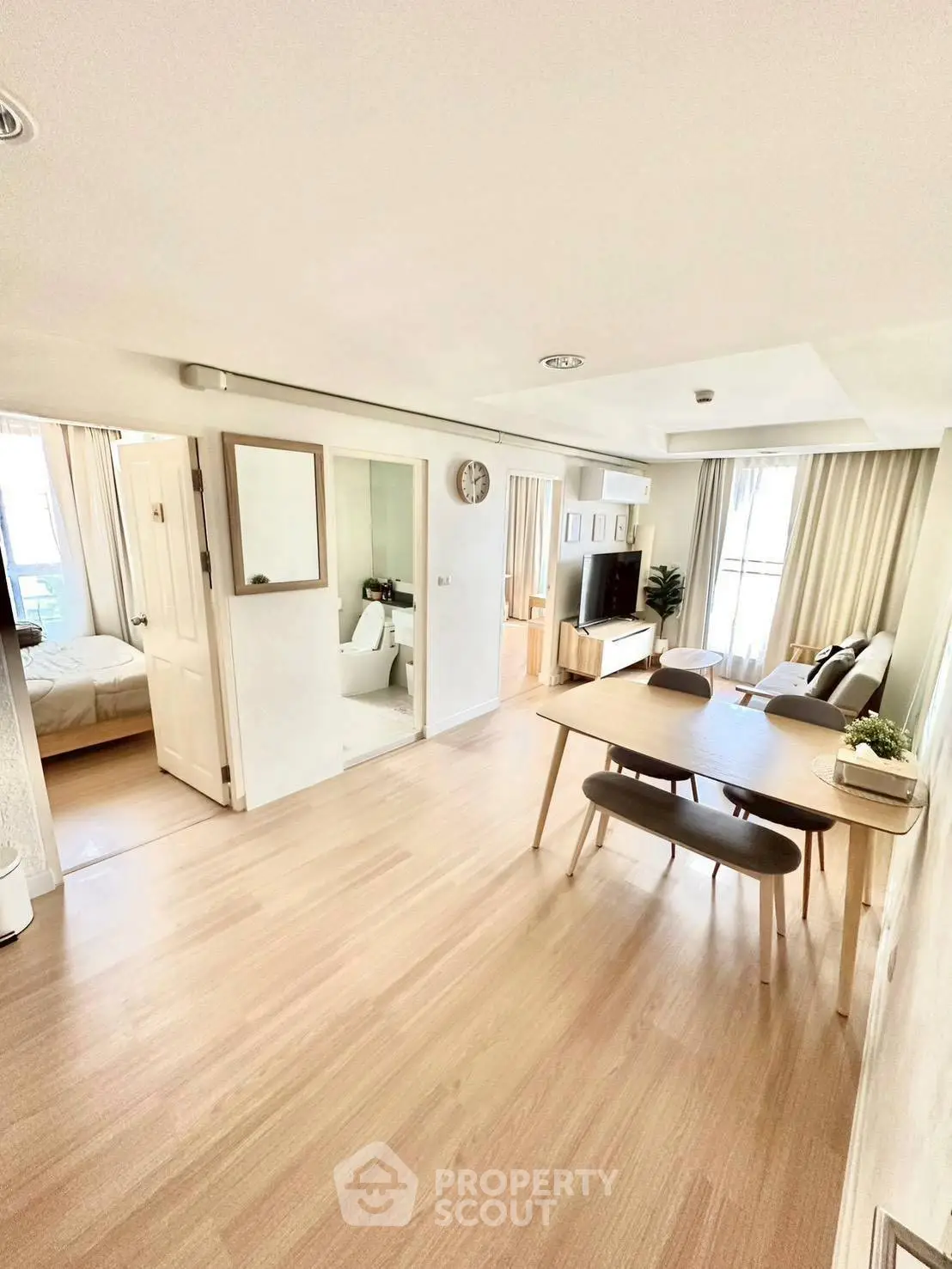 Spacious modern living room with dining area and natural light
