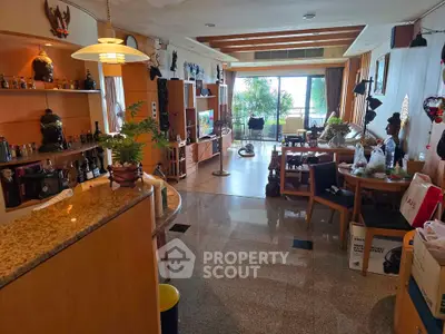 Spacious living room with modern decor and large windows offering natural light.