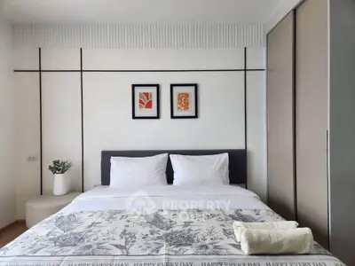 Modern bedroom with stylish decor and cozy bedding in a contemporary apartment.