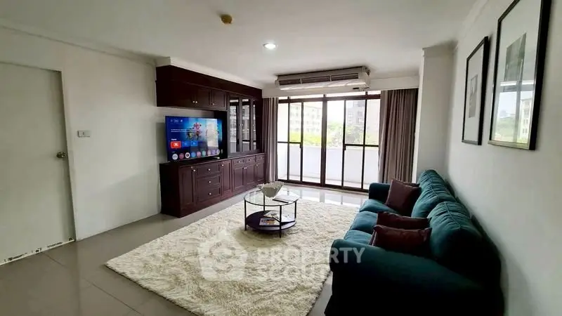 Spacious living room with modern decor and large windows offering natural light.