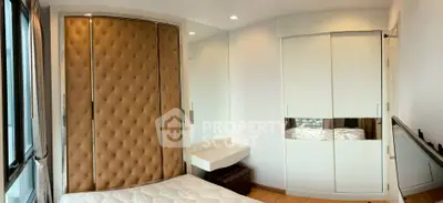 Modern bedroom with stylish padded wall and mirrored wardrobe