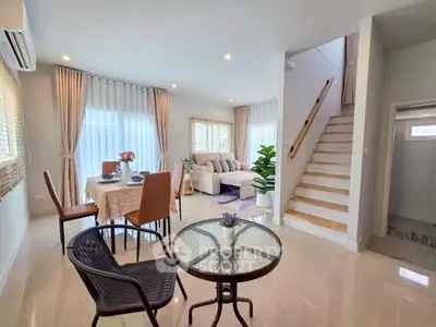 Spacious modern living room with dining area and staircase in elegant home