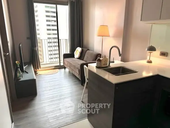 Modern apartment living room with open kitchen and balcony view