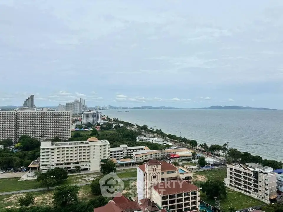 Stunning coastal cityscape view from high-rise building overlooking ocean and skyline.