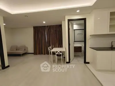 Spacious open-plan living area with modern kitchen and cozy seating.