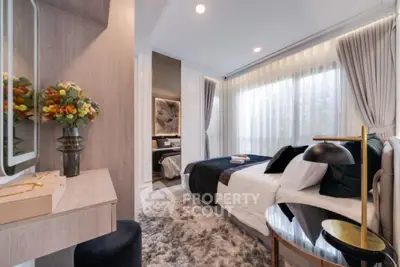 Luxurious bedroom with elegant decor and plush rug, featuring large windows and stylish furnishings.