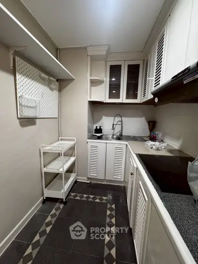 Charming compact kitchen with modern cabinetry and sleek countertops