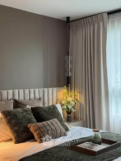 Luxurious bedroom with elegant decor and plush bedding, featuring modern lighting and stylish curtains.