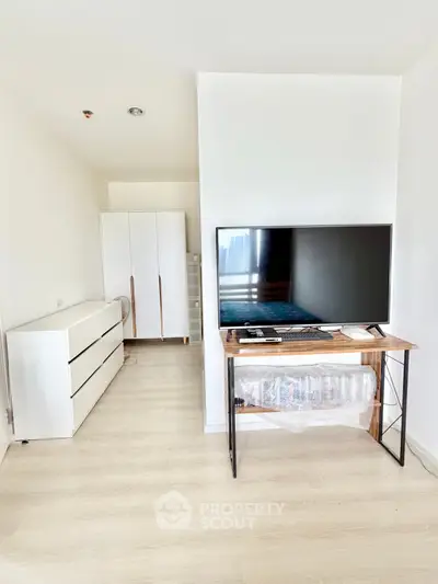 Modern living room with sleek TV setup and minimalist furniture design.
