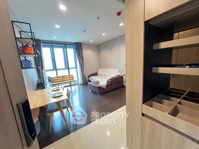 Modern living room with wooden flooring, cozy sofa, and dining area in open layout apartment.