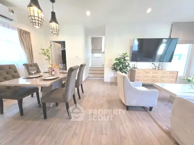 Spacious modern living room with elegant dining area and large TV