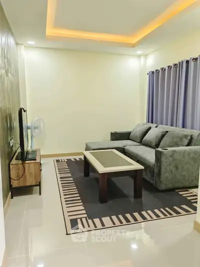 Modern living room with stylish sofa, elegant coffee table, and ambient lighting for a cozy atmosphere.