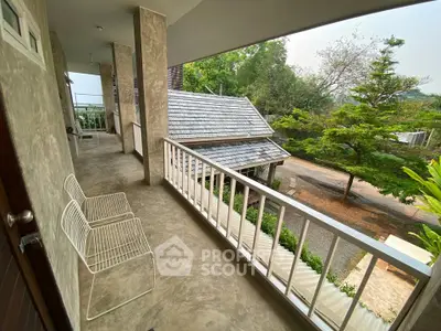 Charming balcony with scenic view and modern seating, perfect for relaxation and enjoying nature.