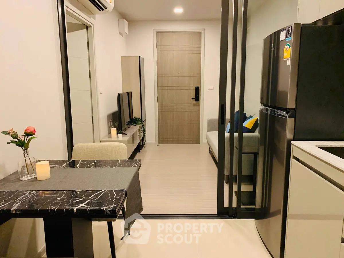 Modern apartment interior with open layout, sleek kitchen, and cozy living area.