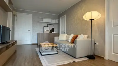 Modern living room with stylish decor and cozy ambiance, featuring a comfortable sofa and elegant lighting.