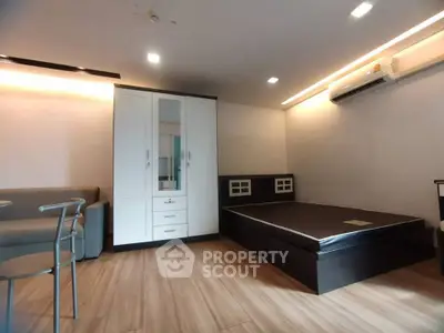 Modern bedroom with sleek furniture and air conditioning in a stylish apartment.