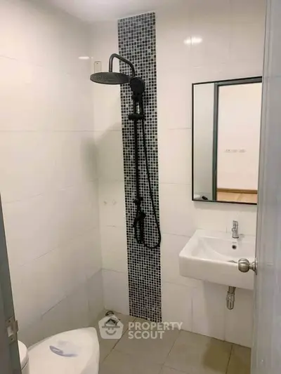 Modern bathroom with sleek shower and minimalist design in a contemporary apartment.