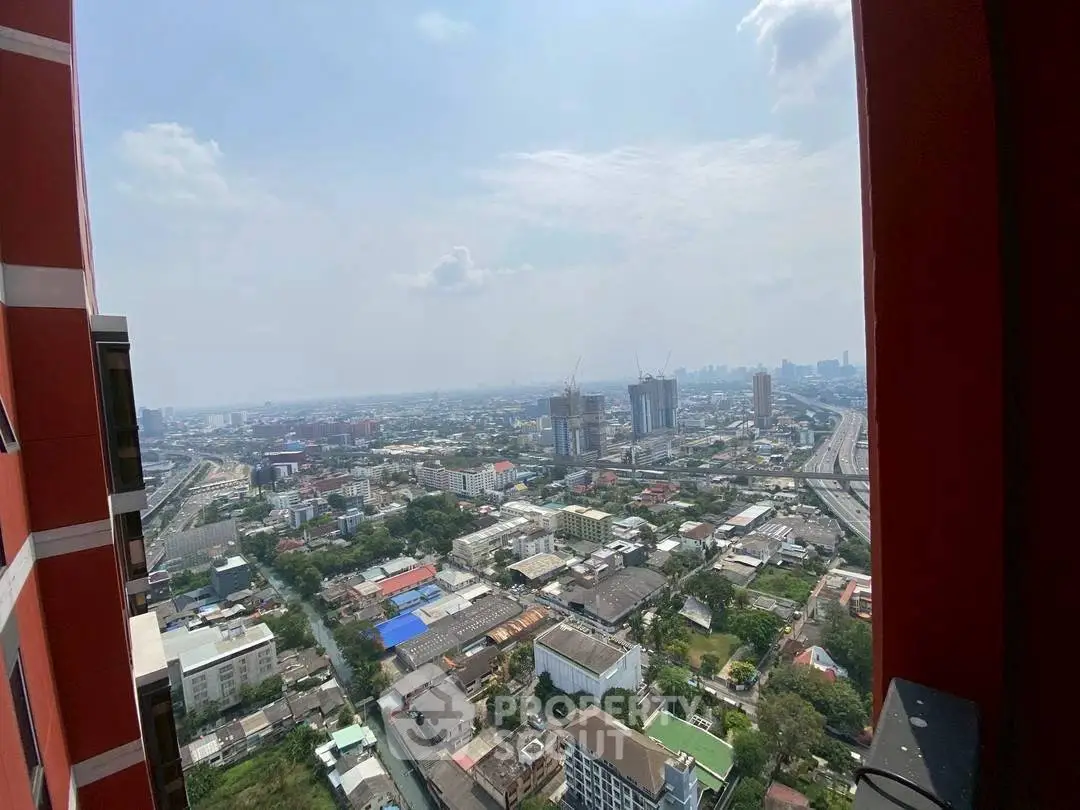 Stunning cityscape view from high-rise building balcony, showcasing urban skyline and expansive horizon.