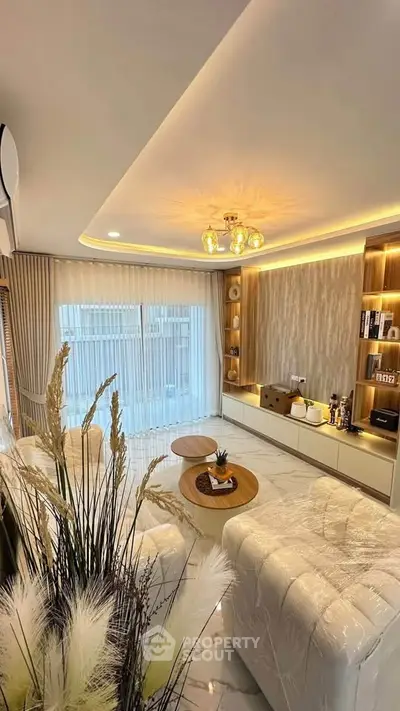 Luxurious living room with modern decor and large windows offering natural light.