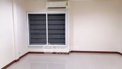 Spacious empty room with air conditioning and large window, ideal for customization.