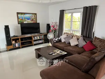 Spacious living room with cozy sectional sofa and entertainment center, perfect for relaxation and entertainment.
