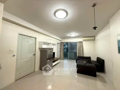 Spacious living room with modern furniture and balcony access in a stylish apartment.