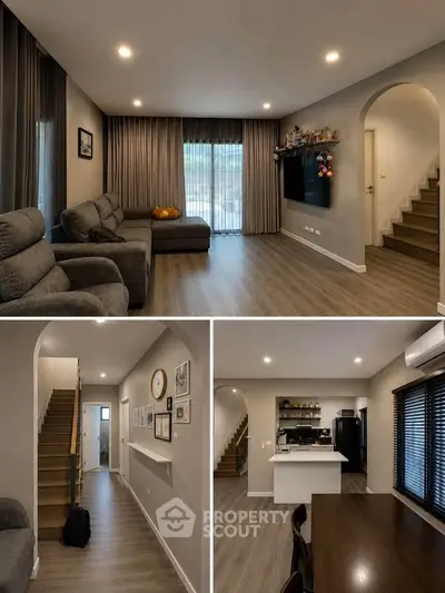 Modern living room with cozy seating, stylish decor, and open kitchen layout in a contemporary home.